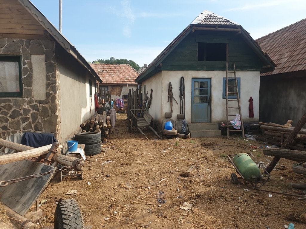 Borat production location showing a rustic rural courtyard