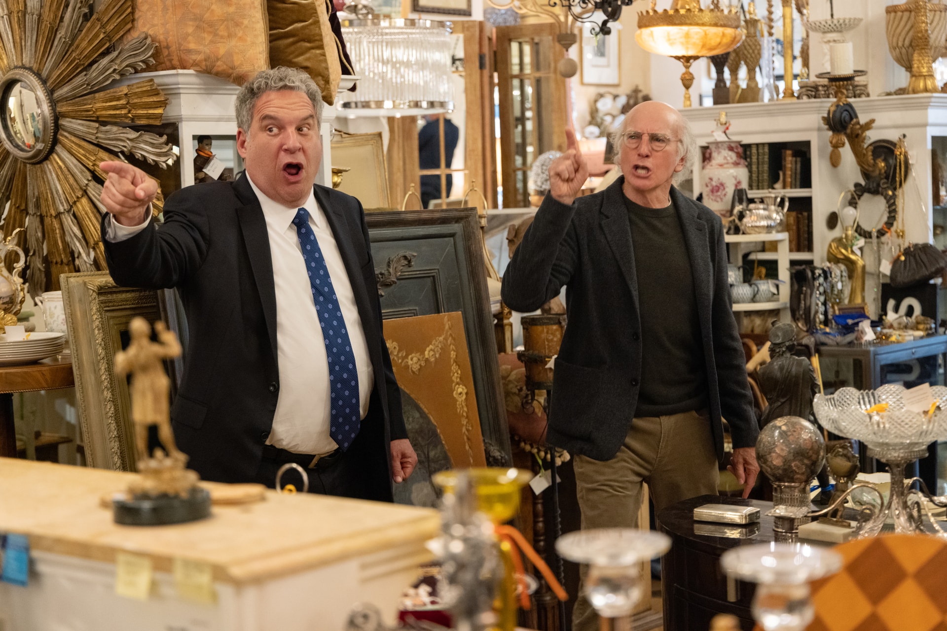 Two men in an antique-filled shop