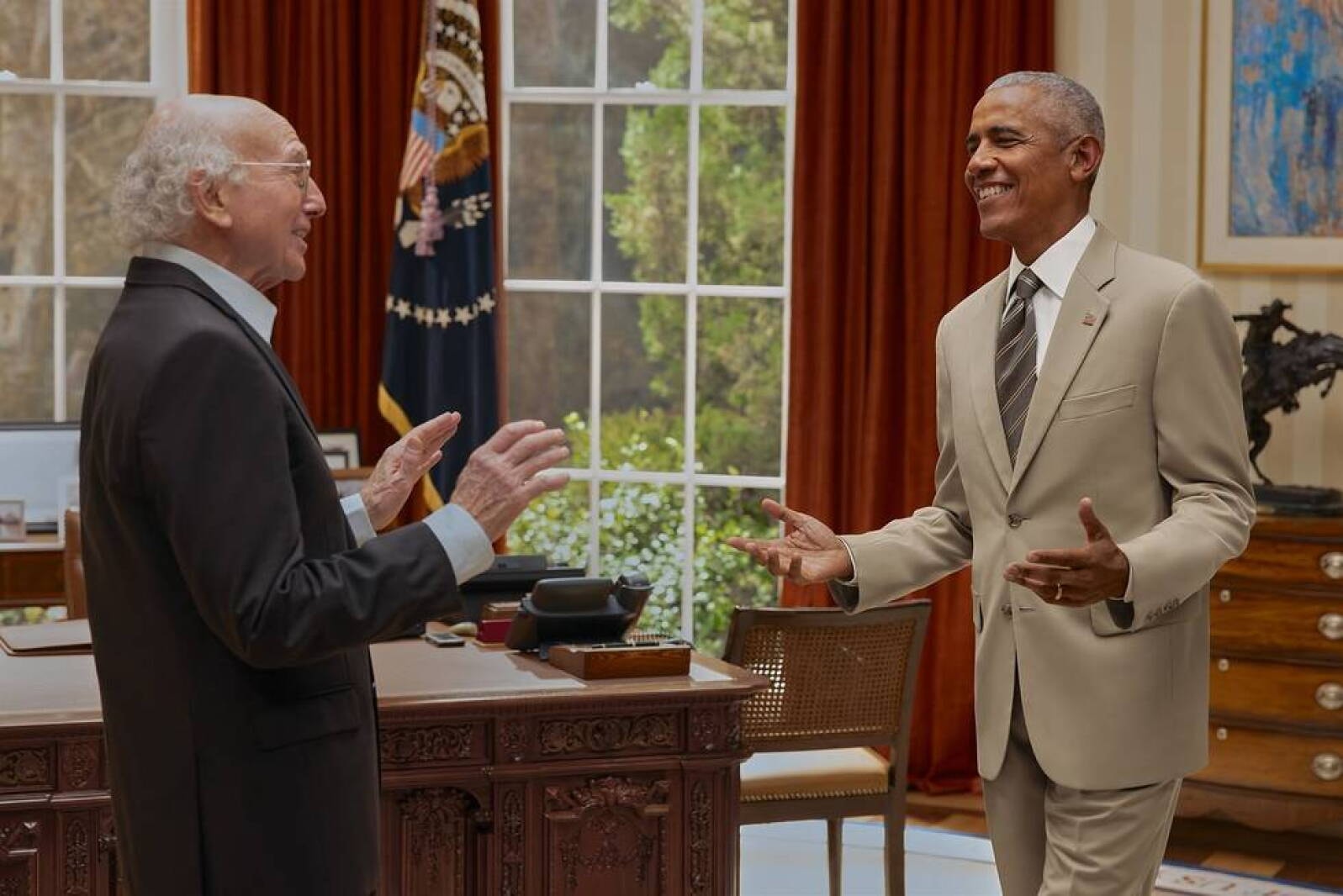 Two men conversing in a presidential office