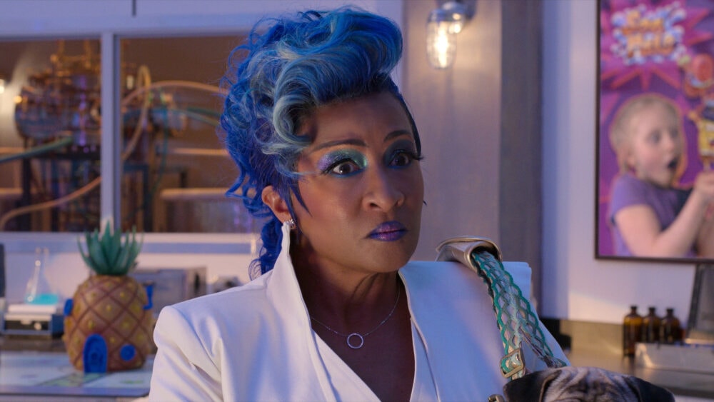 Blue-haired woman in a colorful interior